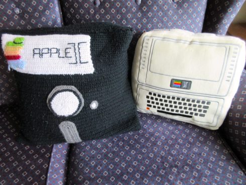 A floppy disk pillow next to the Apple II pillow.