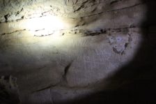 Names etched into a cave wall.