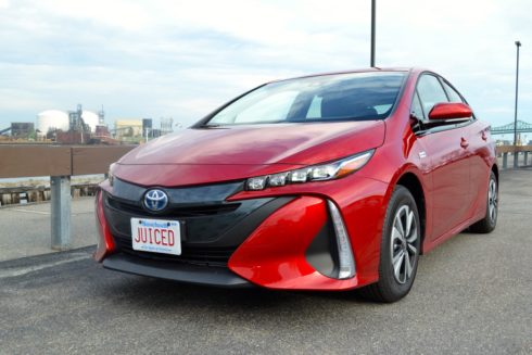 A red Toyota Prius Prime with JUICED license plate